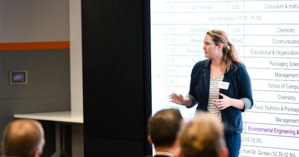 Sarah Donaher presents her work in front of an audience.